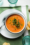 cream soup of red lentils with tomatoes on the table. healthy vegan warming food for the whole family