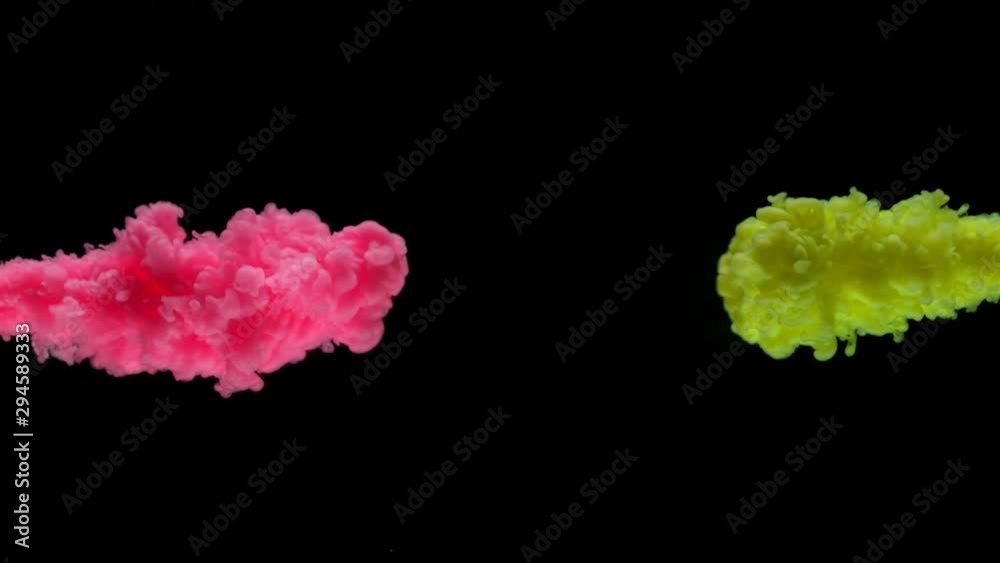 Super slow motion of coloured inks in water. Isolated on black background. Filmed on high speed cinema camera.