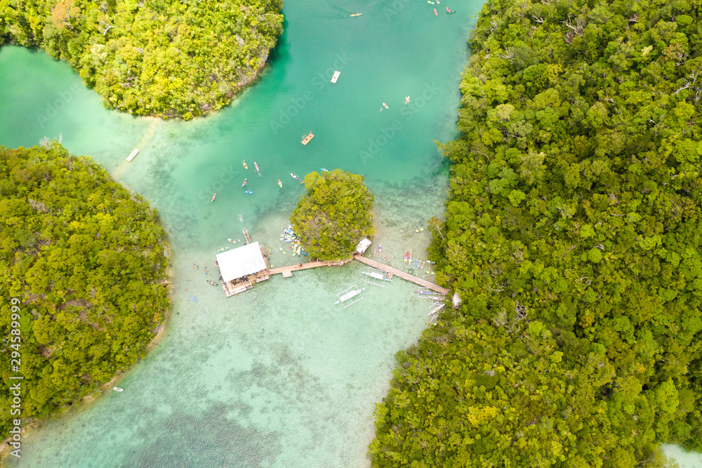 Cove and blue lagoon among small islands covered with rainforest. Sugba lagoon, Siargao, Philippines. Aerial view of Sugba lagoon, Siargao,Philippines.