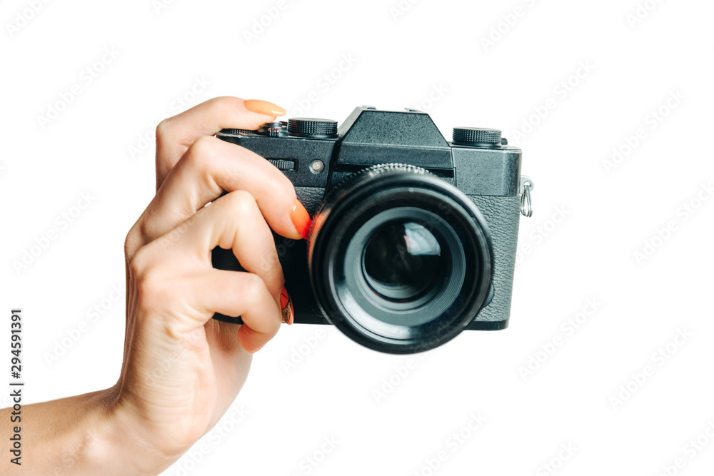 Female hand with photo camera on a white background.