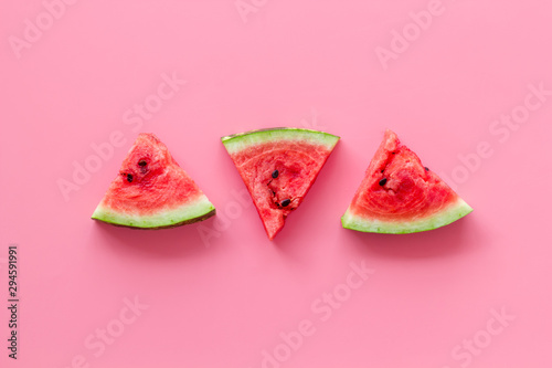 Fresh watermelon on pink background top view