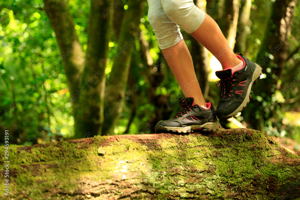 detail girl walking on trunk with green moss 