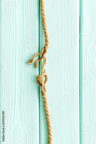 stress concept with breaking rope on mint green wooden background top view mockup