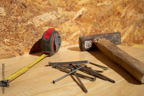 Hammer, Nails, tape measure on wood