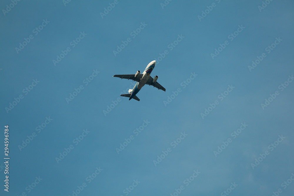 the airplane passenger is flying through the blue sky the airplane passenger is flying through the blue sky