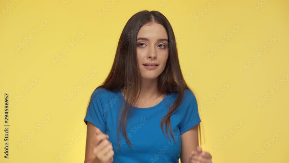 pretty woman snapping fingers and dancing isolated on yellow pretty woman snapping fingers and dancing isolated on yellow