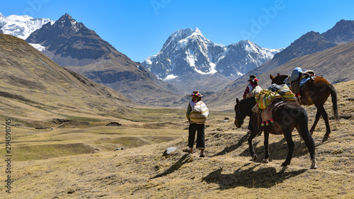 Horsemen in traditional Quechua dress following trails through the Andes. Ausungate trail, Cusco, Peru © Mark