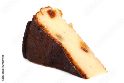 Slice of Cheesecake with raisins. Isolated on a white background