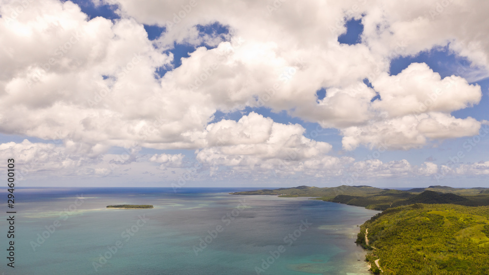 Seascape, coast of the island of Siargao, Philippines. Blue sea with waves and sky with big clouds, top view. Seascape, coast of the island of Siargao, Philippines. Blue sea with waves and sky with big clouds, top view.