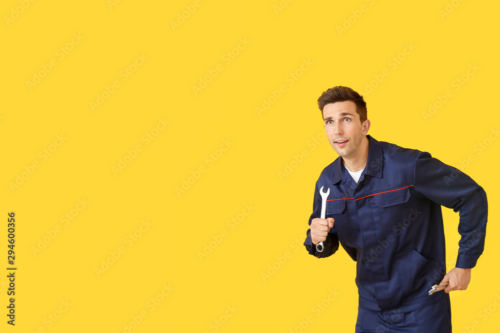Running car mechanic on color background Running car mechanic on color background