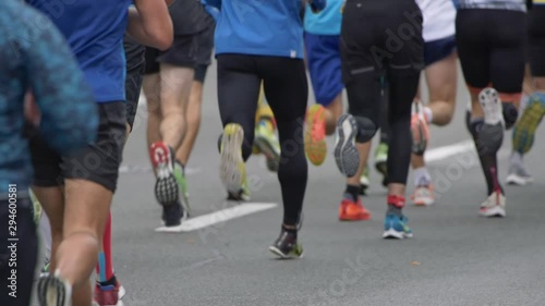Wallpaper Mural Urban marathon runners running on city road. Slow motion shot Torontodigital.ca