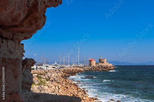 View of Mandraki port, yachts, red-roofed mills and St. Nicholas Fort, Rhodes