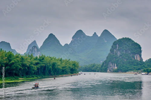 Tourist boats on Li river with carst mountains in the background © Dmitry Rukhlenko