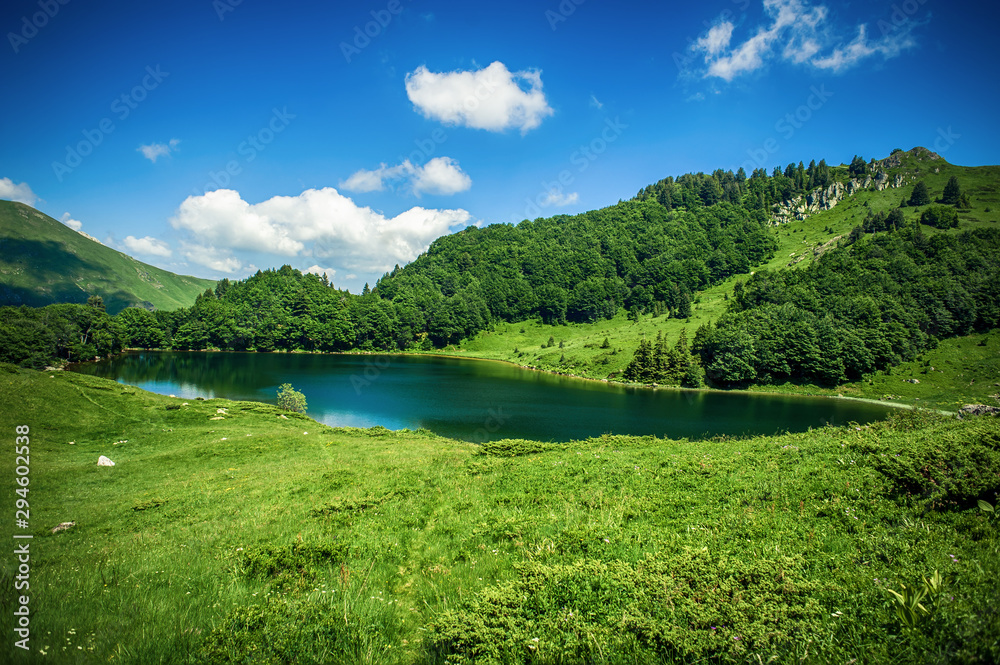 Panoramic view of beautiful mountain range with crystal clear lake Panoramic view of beautiful mountain range with crystal clear lake