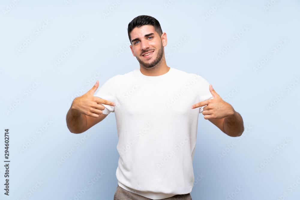 Fototapeta premium Caucasian handsome man over isolated blue background proud and self-satisfied