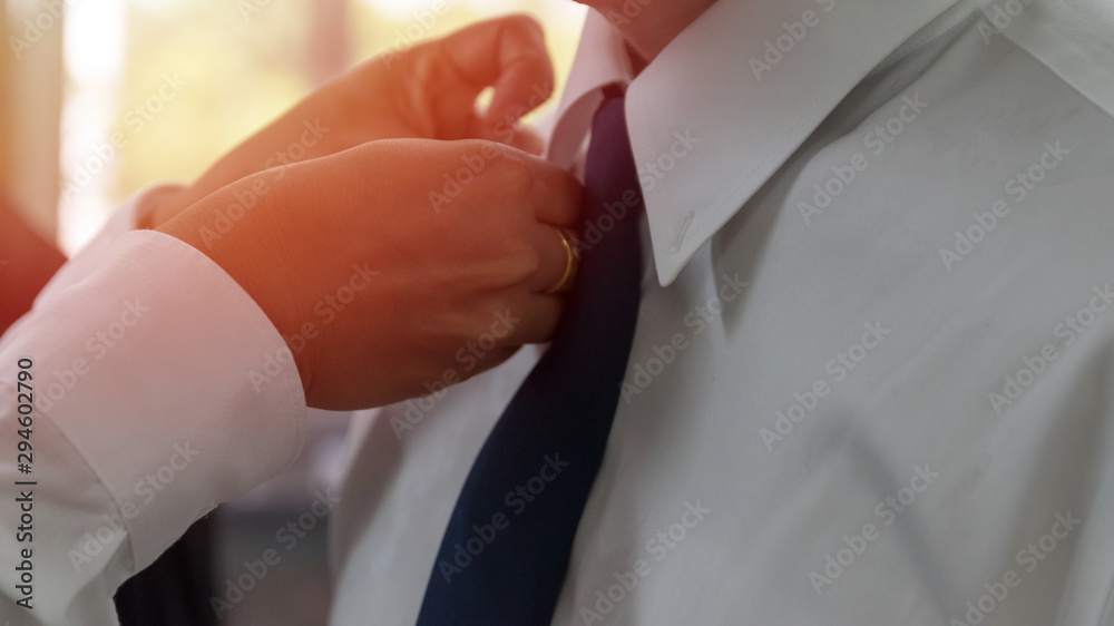 Gay couple, LGBT, LGBTQ+ concept. Hands of man taking care of  another male dress up and tie necktie