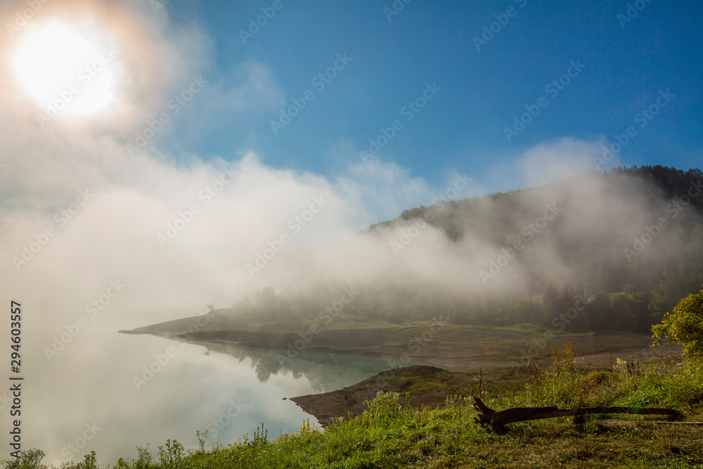 Fog over lake landscape of Zaovine lake on Tara mountain.
