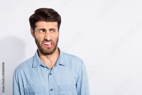 Ugh ew. Photo of amazing mixed race guy looking disgusted on spoiled food terrible smell wear casual denim shirt isolated white color background