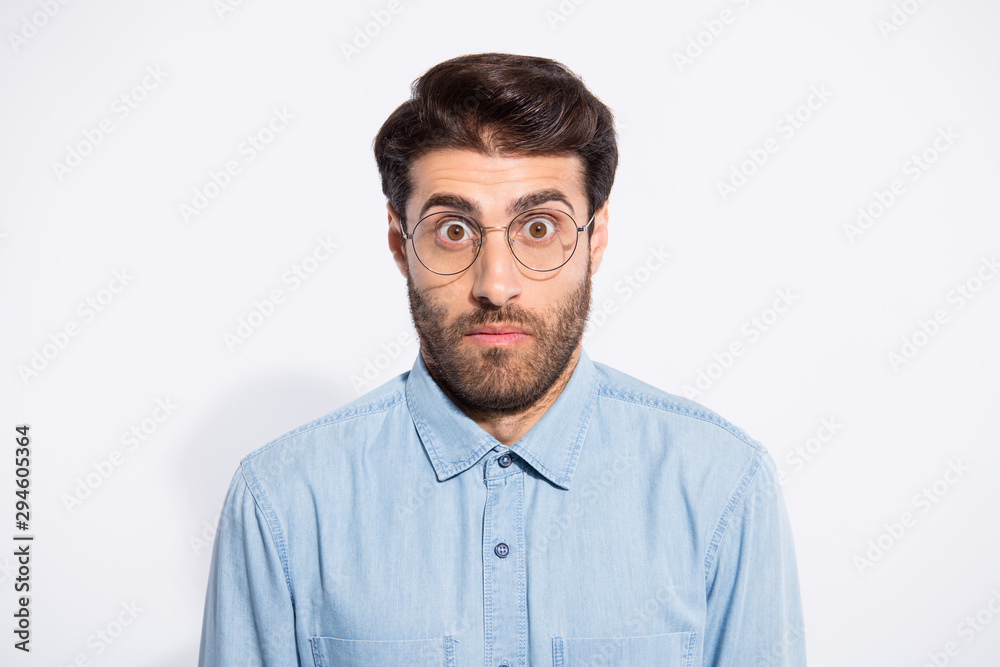 Close up photo of amazing indian guy looking big eyes feel guilty blamed for awful situation wear specs casual denim shirt isolated white color background Close up photo of amazing indian guy looking big eyes feel guilty blamed for awful situation wear specs casual denim shirt isolated white color background