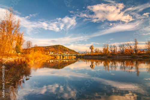Mirroring autumn landscape in The Vah river near The Zilina town, Slovakia, Europe. photo