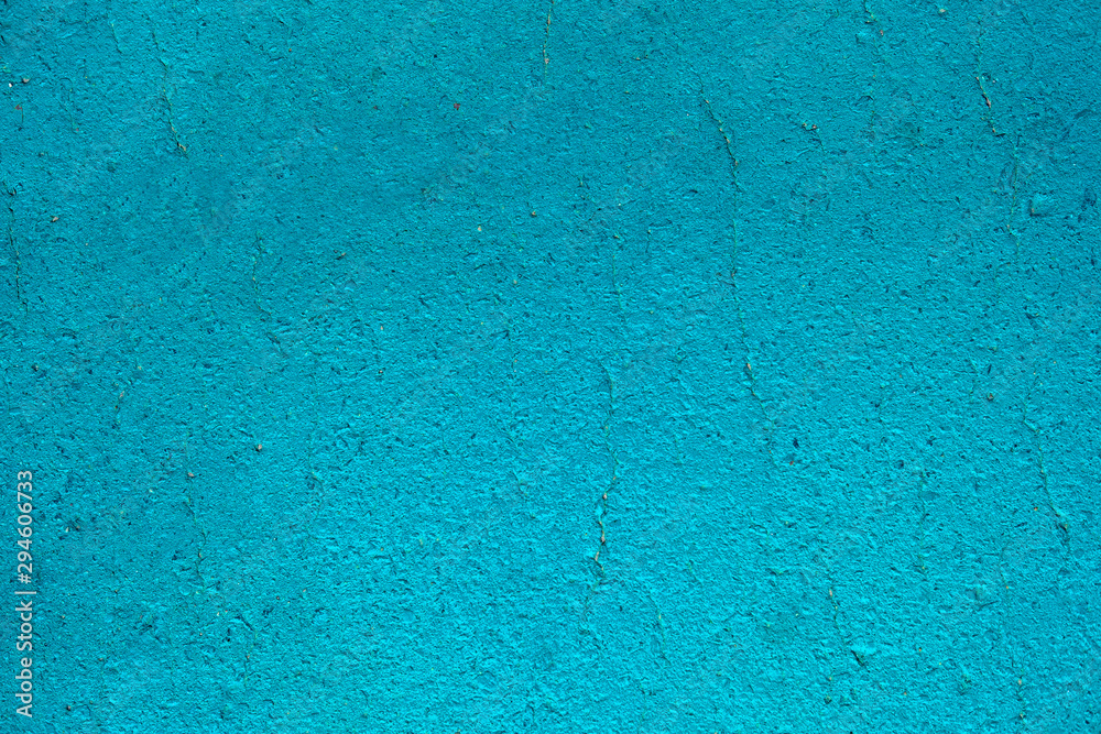 Bright blue cement or concrete wall texture background. Old painted cracked wall close up with copy space Bright blue cement or concrete wall texture background. Old painted cracked wall close up with copy space