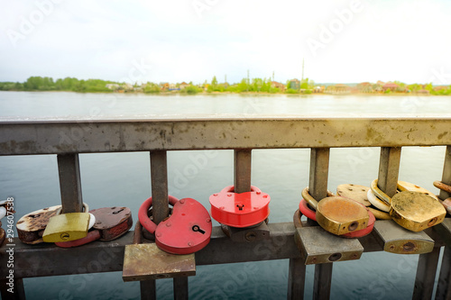 Lock for couple make a promise to love forever, master keys are hanging on the rails of bridge, the sign of love and romantic affection as a landmark of Irkutsk, Russia.