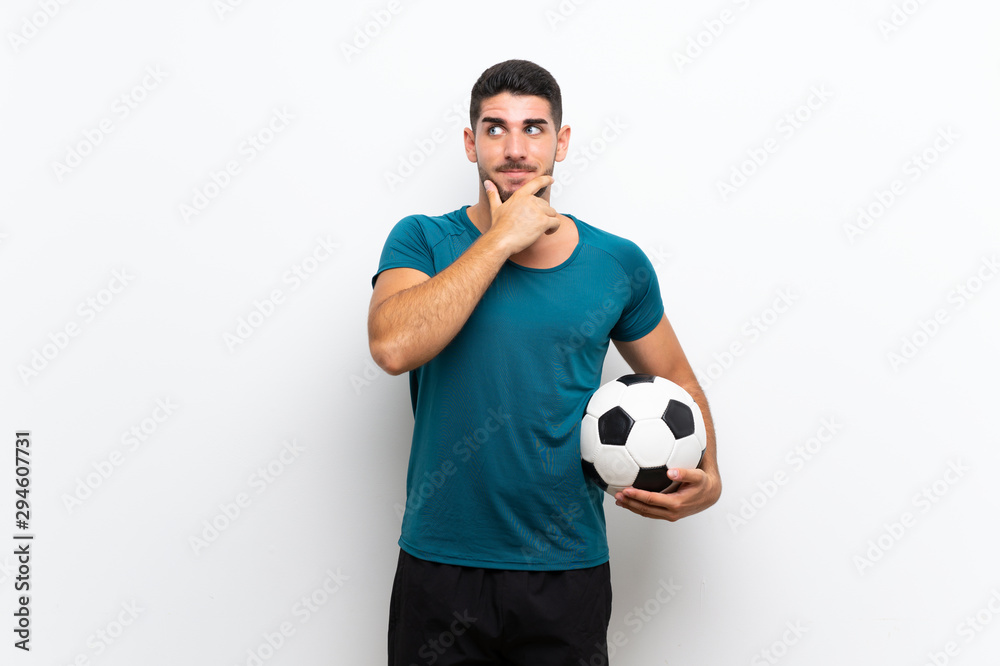 Handsome young football player man over isolated white wall thinking an idea