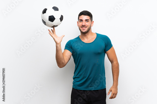 Handsome young football player man over isolated white wall