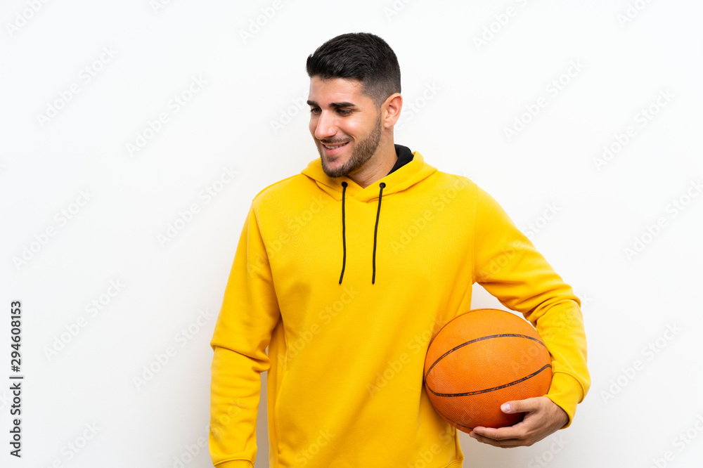 Handsome young basketball player man over isolated white wall smiling a lot