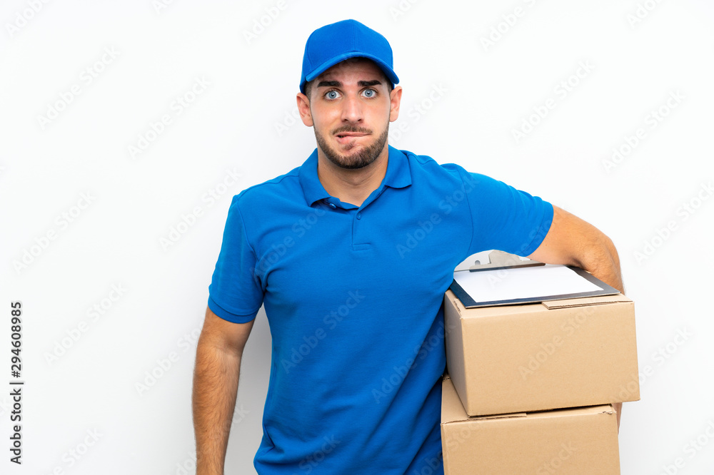 Delivery man over isolated white background having doubts and with confuse face expression Delivery man over isolated white background having doubts and with confuse face expression