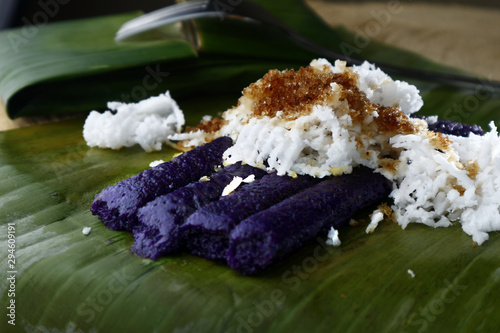 Photo of freshly cooked Filipino delicacy called puto bumbong or ground purple glutenous rice steamed in bamboo tubes photo