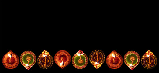 Diwali, Hindu festival of lights celebration. Diya oil lamps against dark background,