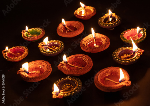 Diwali, Hindu festival of lights celebration. Diya oil lamps against dark background,