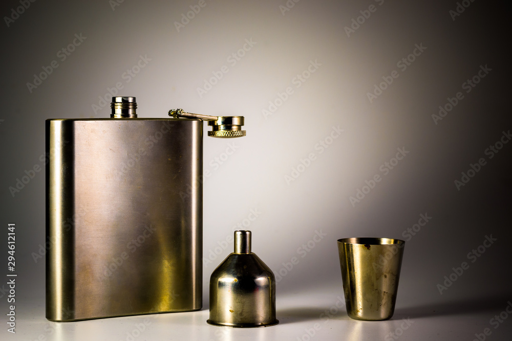 Metallic container for liquid, alcohol, whiskey and cognac. Old classic pocket vessel.