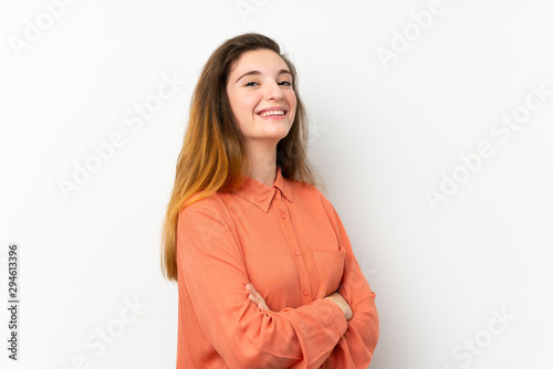 Young brunette girl over isolated white background with arms crossed and looking forward