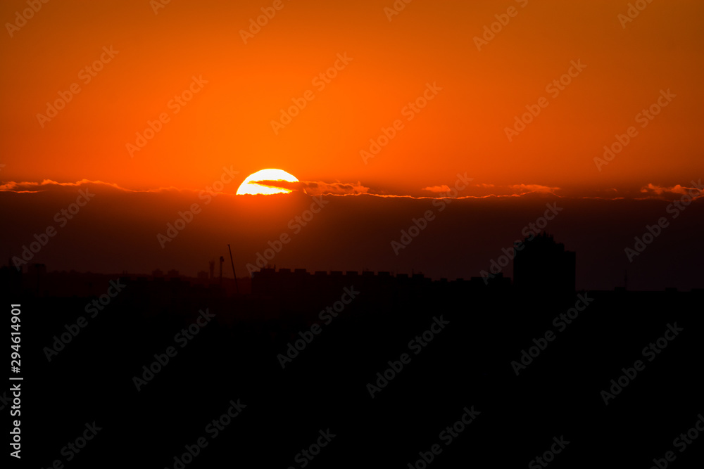 Orange sunset on horizon with big orange sun
