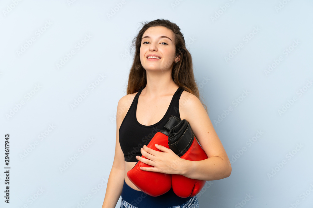 Young brunette girl with boxing gloves over isolated background Young brunette girl with boxing gloves over isolated background