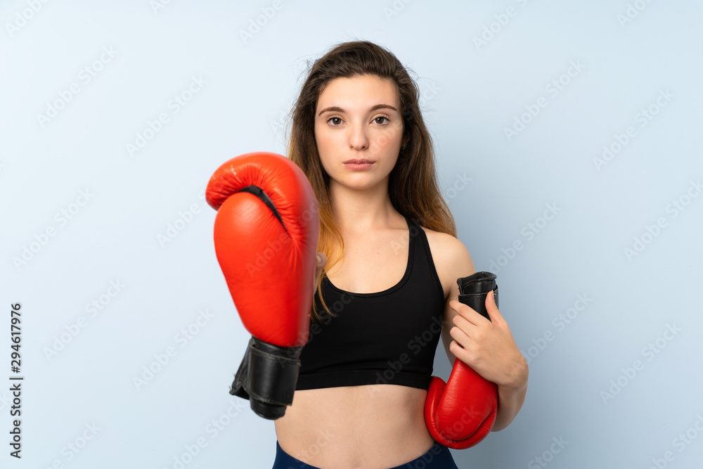 Young brunette girl with boxing gloves over isolated background Young brunette girl with boxing gloves over isolated background