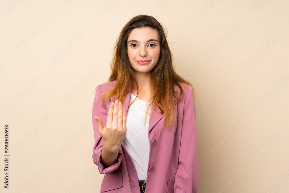 Young brunette girl with blazer over isolated background inviting to come with hand. Happy that you came Young brunette girl with blazer over isolated background inviting to come with hand. Happy that you came