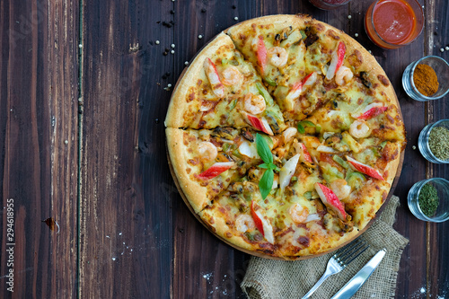 pizza on the wood table. Top view with copyspace for your text