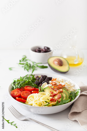 ketogenic lunch bowl: spiralized courgette with avocado, tomato, feta cheese, olives, bacon