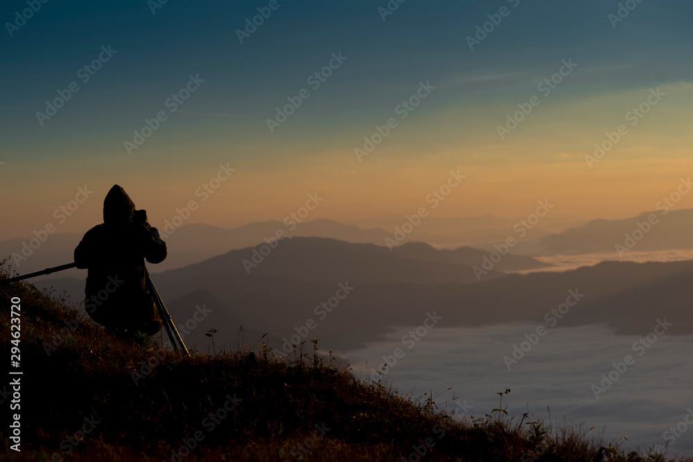 Photographer photographed mist and sky On a high mountain in the morning.
