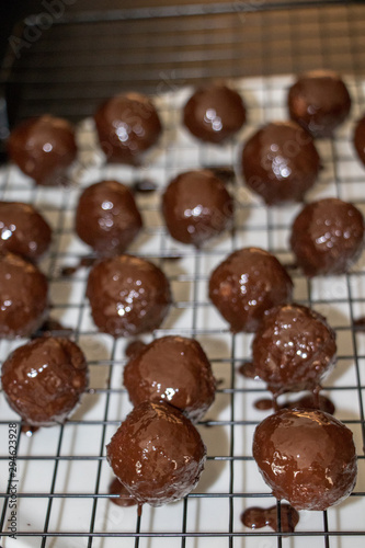 a few chocolate balls on iron net, close up