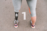 partial view of disabled sportswoman with prosthesis on street