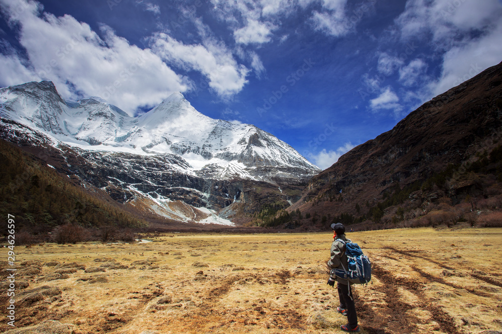 A man carrying backpack before hiking at Yading Nature Reserve, Daocheng China, during autumn
