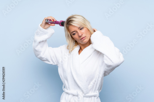 Young woman in a bathrobe with hair comb.