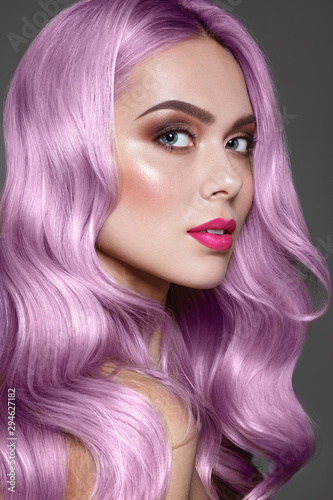 Purple or Pink hair. Dye for coloring. Close up portrait of fashion model with stylish make up, pink lips and brown eye shadow.