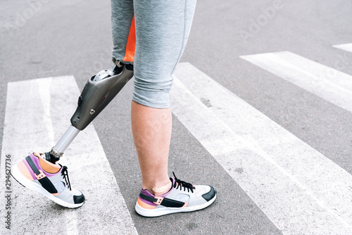 partial view of disabled woman with prosthesis on street