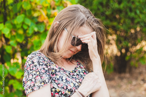 Woman looking down with shame