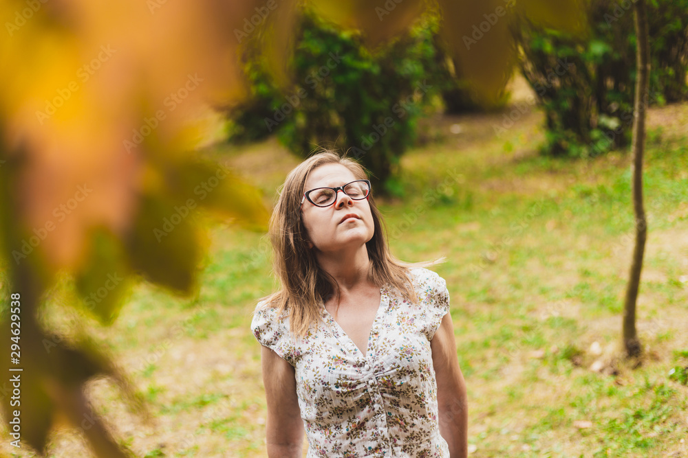 Woman inhaling fresh air in nature